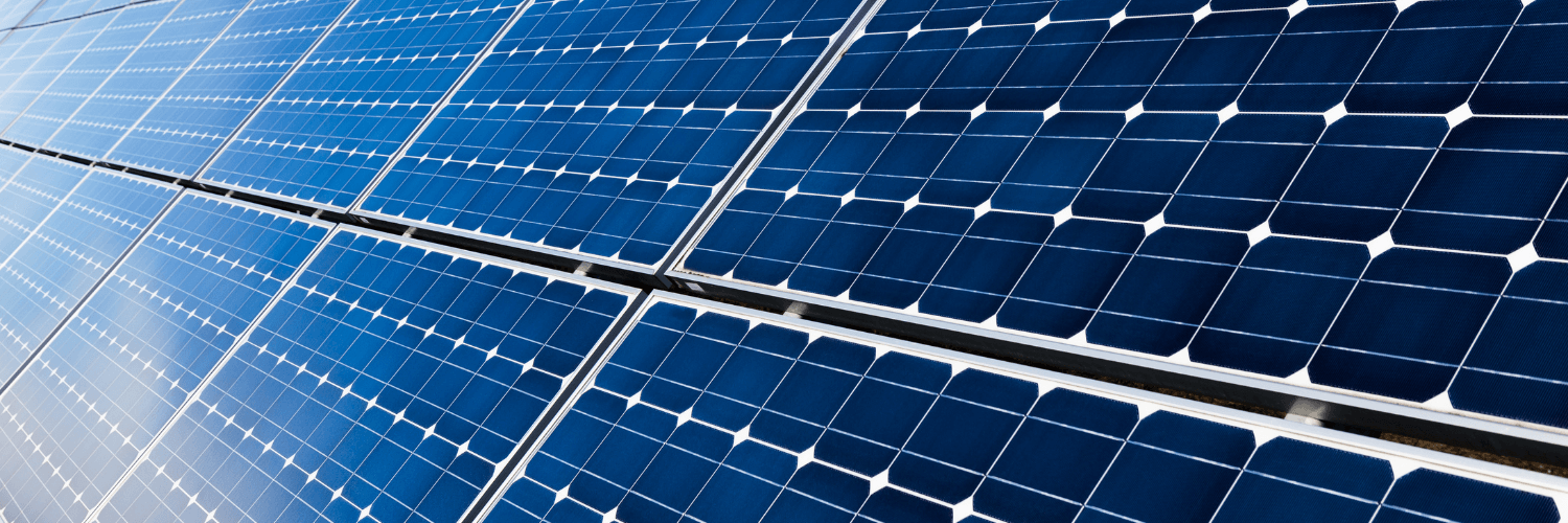 Angled view of blue solar panels absorbing sunlight for energy