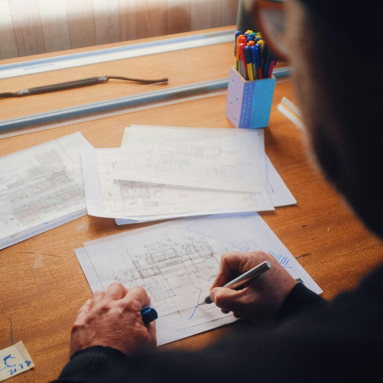 Engineer reviewing architectural blueprints for a solar project